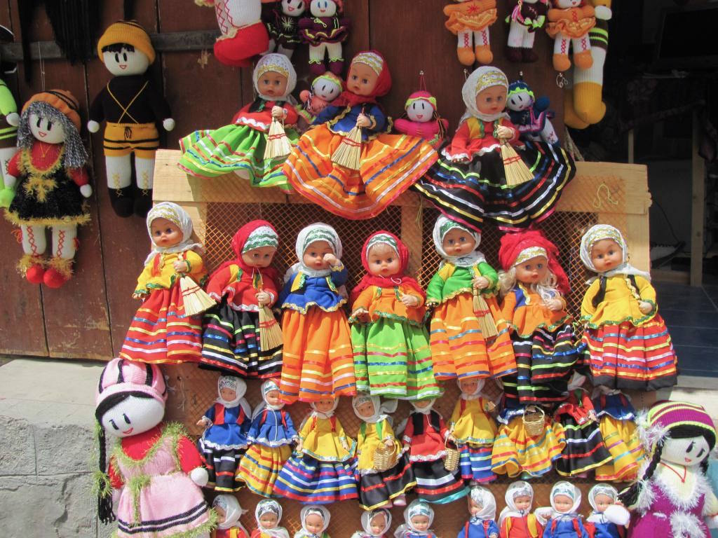 Young and old selling colourful dreamlike dolls in the alleys of Masuleh.